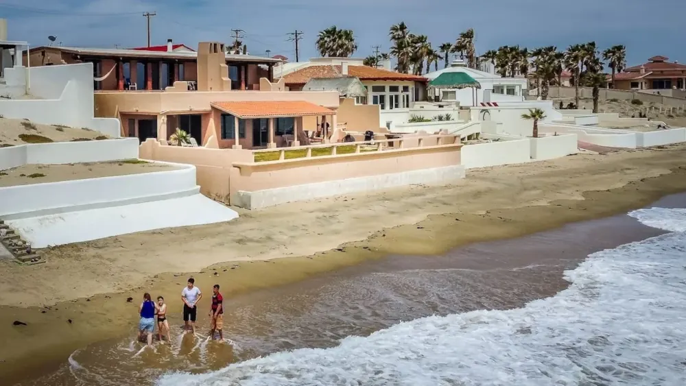 Aerial view of Rocky Point’s coastline, with beach houses visible in the background.